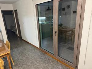 a sliding glass door in a room with a table at Departamento belgrano in San Martín de los Andes