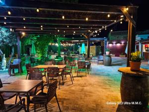 an outdoor restaurant with tables and chairs and lights at Hotel Restaurante EL PATAS in Corral de Almaguer