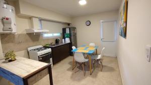 a small kitchen with a table and chairs in it at Departamento 20 in Necochea