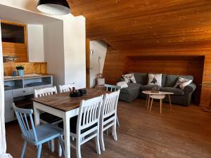 a living room with a table and a couch at Obinghof in Fieberbrunn