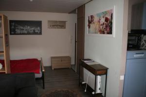 a small living room with a table and a desk at Fels- und Seenland in Ludwigswinkel