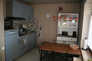 a kitchen with a wooden table and a table and chairs at Fels- und Seenland in Ludwigswinkel +13 photos