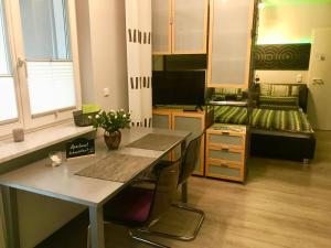 a kitchen with a table and a bed in a room at Apartment Schwabthal by Landhaus Staffelstein in Bad Staffelstein