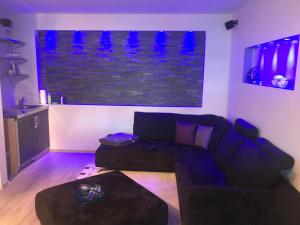 a living room with a couch and a table at Apartment Schwabthal by Landhaus Staffelstein in Bad Staffelstein +8 photos