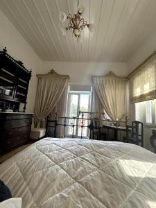 a bedroom with a large bed and a window at Abella Maison, Kythnos in Kithnos +21 photos