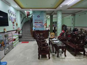 a room with chairs and tables and a staircase at Khách Sạn Minh Nhựt in Rạch Giá +15 photos
