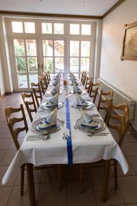 a long table with plates and napkins on it at Hotel Restaurant Brinckwirth in Ochtrup