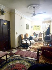 a living room with couches and chairs and a ceiling at The stunning of Ismailia's House in Ismailia