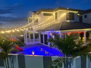 a house with a swimming pool at night at C&C Villa Pool Ipoh in Ipoh