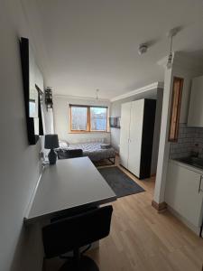 a kitchen and living room with a table in a room at Stylish & compact city center studio apartment 7a in Norwich