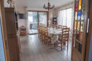 a dining room with a table and some chairs at Villa des champs in Villers-sous-Foucarmont