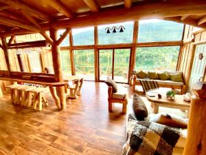 a large living room with a large window at Refugio del Chucao in Llanada Grande