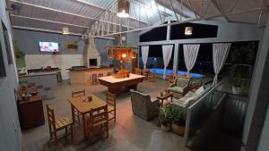 an aerial view of a living room with a table and chairs at Pousada Água Doce - Porto Eucalipto in Pôrto São José