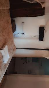 a white bed in a room with a ceiling at Maseno Castles Resort in Kisumu