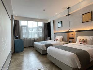 Lijiang MΛISON Hotel客房内的一张或多张床位