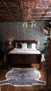 a bedroom with a bed with a zebra rug at St Hildas Complex in Hinderwell