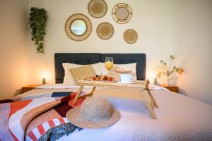 a tray of food and a hat on a bed at 150m to Beach - Free Parking - Garden View in Slano