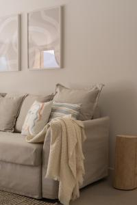 a couch with a blanket on it in a living room at A Casiña in Nigrán