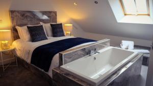 a bedroom with a bed and a bath tub at St Hildas Complex in Hinderwell