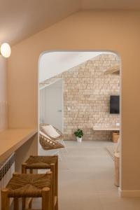 a living room with a brick wall and a mirror at A Casiña in Nigrán +12 photos