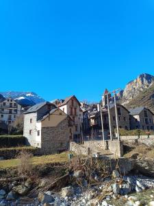 a group of houses on a hill next to a river at Caseta Sorripas in Bielsa