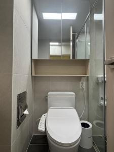 a small bathroom with a toilet and a mirror at E7 Yangyang Jukdo in Yangyang