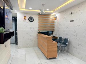 a kitchen with a desk and chairs in a room at Hotel G-3 in Jalandhar