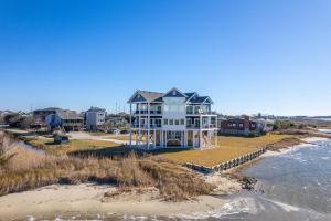 a house on the beach next to the water at NH599 Nags Head 599 in Nags Head