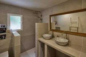 two sinks in a bathroom with a large mirror at Casa El Sueño in Jávea
