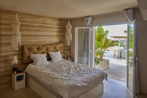 a bedroom with a bed and a sliding glass door at Casa El Sueño in Jávea