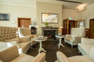 a living room with couches and a fireplace at Berghotel Eisenach in Eisenach