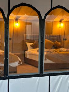 a view of a bedroom through a window at Milagro Luxury camp & AC in Merzouga
