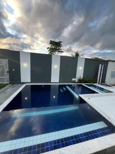 a swimming pool with blue tiles on a building at Casa luxo ferias in Porto Seguro