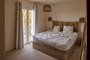 a bedroom with a bed and a sliding glass door at Casa El Sueño in Jávea