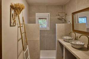 a bathroom with two sinks and a mirror at Casa El Sueño in Jávea