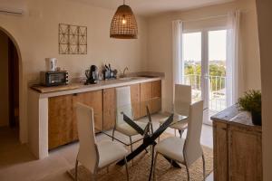 a kitchen with a table and chairs and a balcony at Casa El Sueño in Jávea