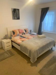 a bedroom with a bed and a window at Spacious Central Penthouse Apartment With Parking in Manchester +3 photos