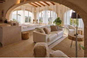 a living room with a white couch and a bed at Casa El Sueño in Jávea