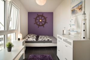 a bedroom with a bed with a nautical wheel on the wall at Neubau Stuttgart Messe Airport in Leinfelden-Echterdingen
