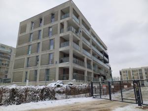 an apartment building with snow in front of it at Apartamenty JAGA parking, FVAT in Kielce +5 photos