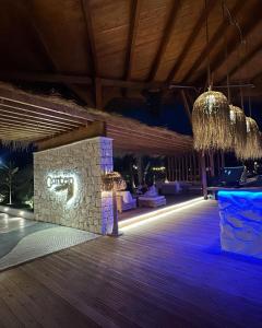 a lobby of a resort with a sign that says club at Lavender Beach House in Draç