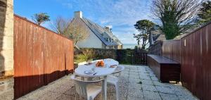a white table and two chairs on a patio at Appartement Reve Marin in Saint-Pierre-Quiberon +6 photos