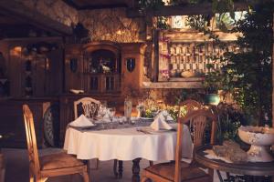 a dining room with a white table and chairs at Fidanka Hotel in Kalkan