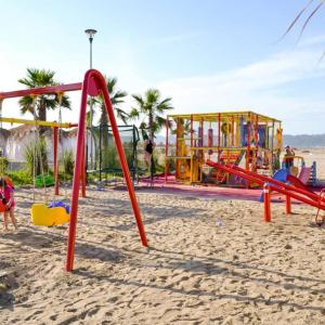 a playground on the beach with people playing at Lavender Beach House in Draç