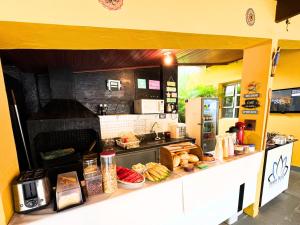 a kitchen with a counter with food on it at Tombo Beach Home Stay in Guarujá