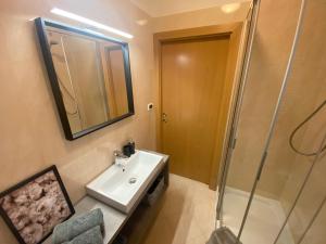 a bathroom with a sink and a shower at Apartment Maximilian in Merano