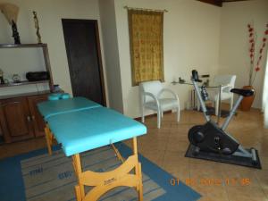 a table and a chair in a living room at Pousada Muriqui in São Francisco Xavier