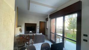 a living room with a couch and a table and a television at Residenza Europa in Budrio