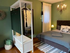 a bedroom with a bed and a mirror at Apartment Maximilian in Merano