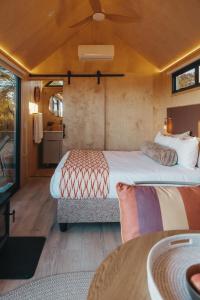 a bedroom with a large bed and a table at Stellenbosch Farm Cabin - Klein Frans in Stellenbosch